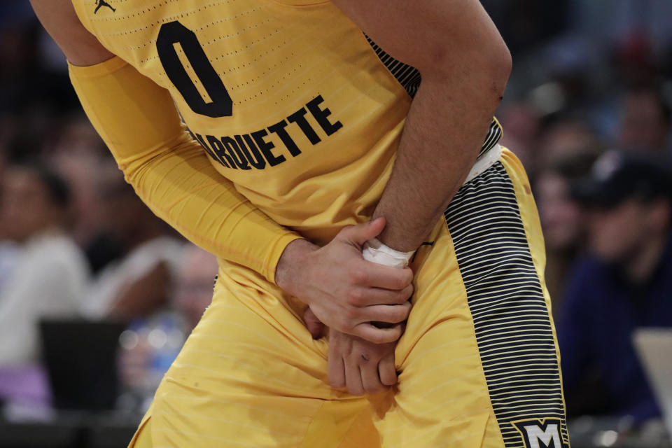 Marquette guard Markus Howard grabs at his wrist during the first half of an NCAA college basketball semifinal game against Seton Hall in the Big East men's tournament, Friday, March 15, 2019, in New York. (AP Photo/Julio Cortez)