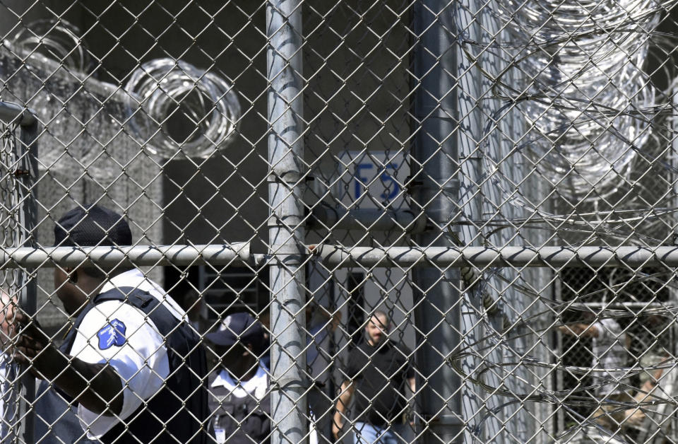 FILE - In this Wednesday, April 10, 2019 file photo, Prison staff work at Lee Correctional Institution in Bishopville, S.C. A slew of new lawsuits accuse South Carolina prisons officials of negligence and constitutional rights violations in a 2018 riot in which seven inmates were killed and more than a dozen others injured. (AP Photo/Meg Kinnard, File)