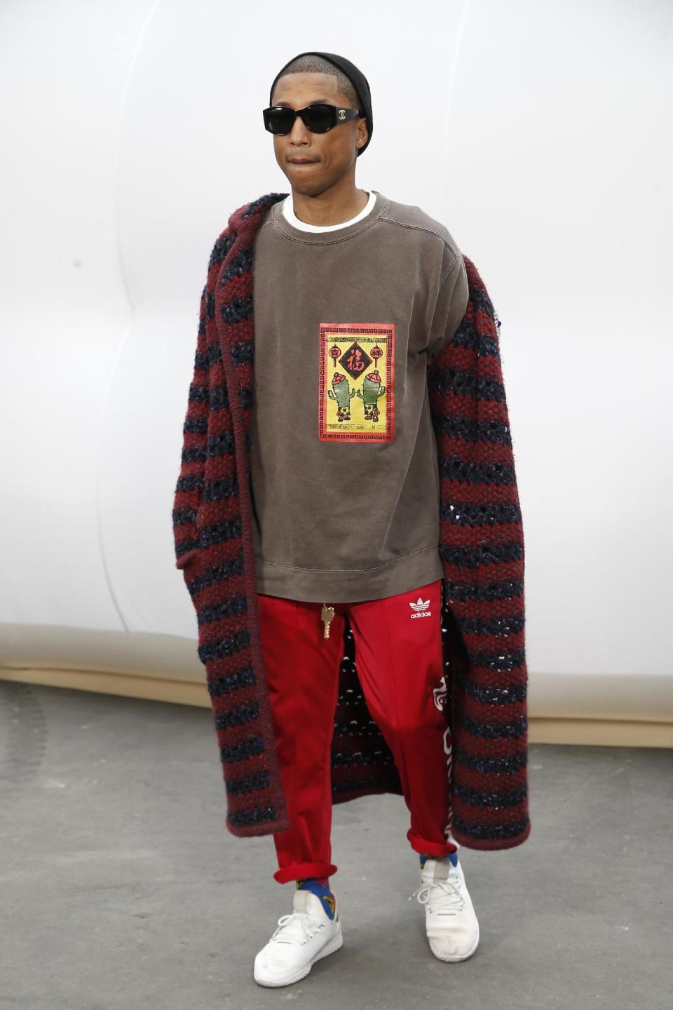 U.S singer Pharrell Williams poses before Chanel's Fall-Winter 2017/2018 ready-to-wear fashion collection, Tuesday, March 7, 2017 in Paris. (AP Photo/Thibault Camus)