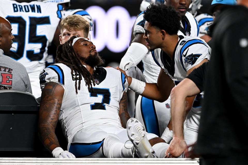 CHARLOTTE, NORTH CAROLINA - SEPTEMBER 18: Shaq Thompson #7 of the Carolina Panthers talks with Bryce Young #9 as he is carted off the field against the New Orleans Saints during the first quarter in the game at Bank of America Stadium on September 18, 2023 in Charlotte, North Carolina. (Photo by Grant Halverson/Getty Images)
