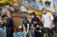 Parents and children wearing face masks participate in a rally to protest against the exposure of children to tear gas by police in Hong Kong, Saturday, Nov. 23, 2019. President Donald Trump on Friday wouldn't commit to signing bipartisan legislation supporting pro-democracy activists in Hong Kong as he tries to work out a trade deal with China. (AP Photo/Ng Han Guan)