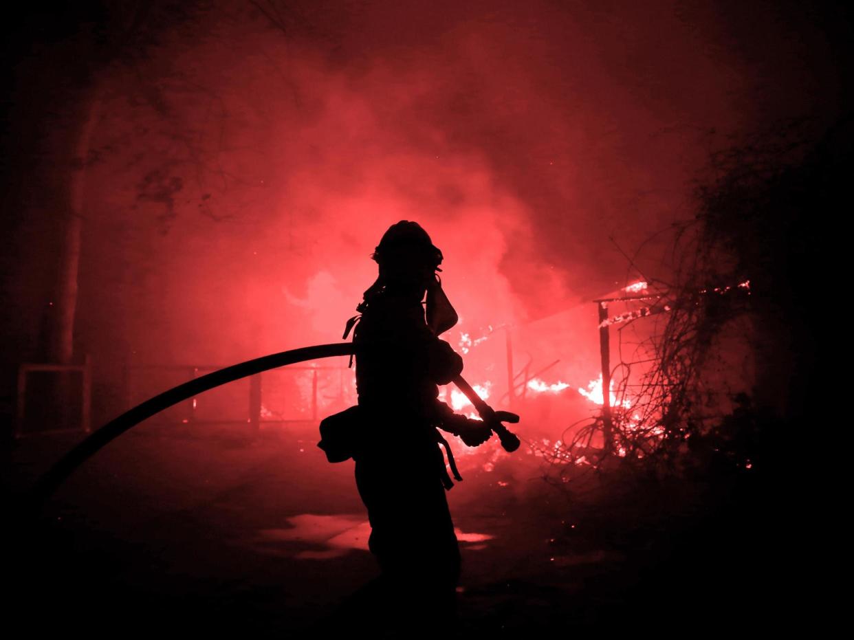 A firefighter battles the Woolsey Fire in Malibu, California: Eric Thayer/Reuters