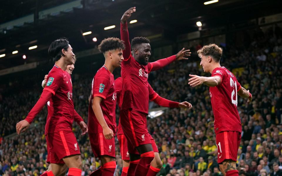 Liverpool's Divock Origi celebrates scoring their side's second goal of the game with team-mates during the Carabao Cup third round match at Carrow Road - Joe Giddens/PA