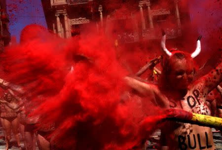 Animal rights protesters break mock banderillas containing red powder during a demonstration for the abolition of bull runs and bullfights a day before the start of the famous running of the bulls San Fermin festival in Pamplona, northern Spain, July 5, 2017. REUTERS/Eloy Alonso