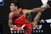 Carlos Alcaraz of Spain serves to Matteo Berrettini of Italy during their third round match at the Australian Open tennis championships in Melbourne, Australia, Friday, Jan. 21, 2022. (AP Photo/Andy Brownbill)