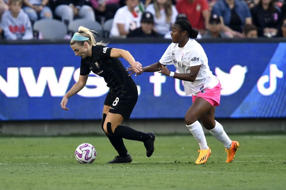 Angel City midfielder Julie Ertz, controls the ball in front of San Diego Wave midfielder Jaedyn Shaw.