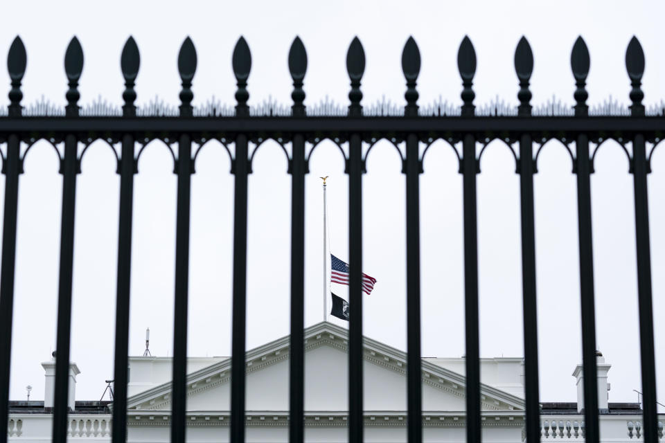 The flags fly at half-staff over the White House by order of President Joe Biden, Wednesday, May 25, 2022, in Washington. (AP Photo/Alex Brandon)
