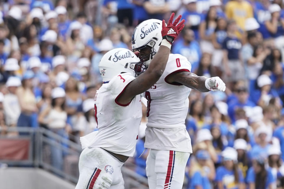 South Alabama running back La'Damian Webb (3) celebrates with wide receiver Jalen Wayne (0) after scoring a touchdown during the first half of an NCAA college football game against UCLA in Pasadena, Calif., Saturday, Sept. 17, 2022. (AP Photo/Ashley Landis)