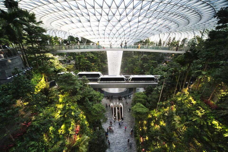 Colorful wide angle view of Giant waterfall in Jewel, Changi Airport at night, Singapore