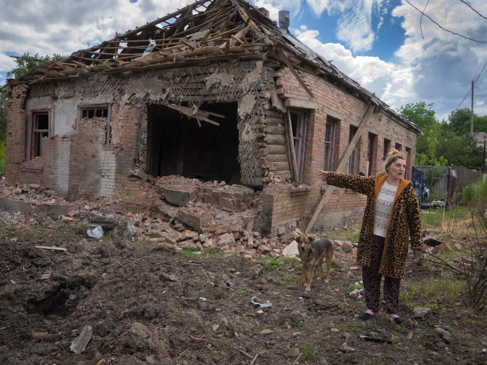 Local resident Tetyana points to her house heavily damaged by the Russian shelling in Bakhmut, Donetsk region, Ukraine, Friday, June 24, 2022.