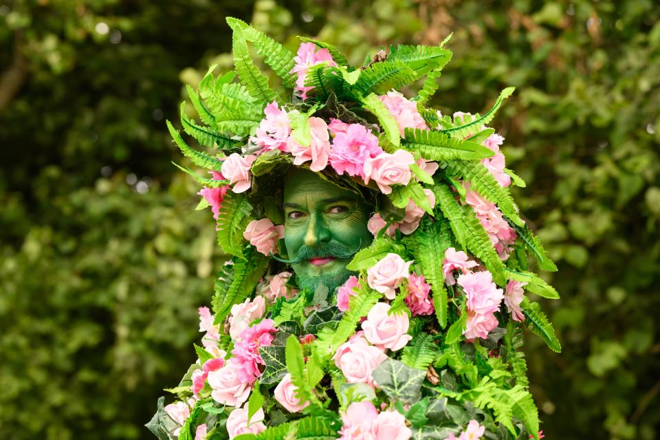 A performer in Green Man costume entertains Glastonbury revellers on day two of the festival (Getty Images)