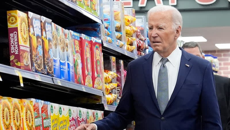 President Joe Biden walks past boxes of cereal in an aisle as he visits Mario's Westside Market in Las Vegas, Tuesday, July 16, 2024. A  majority of Democrats want President Joe Biden to step down from his reelection campaign for president, according to a recent poll.