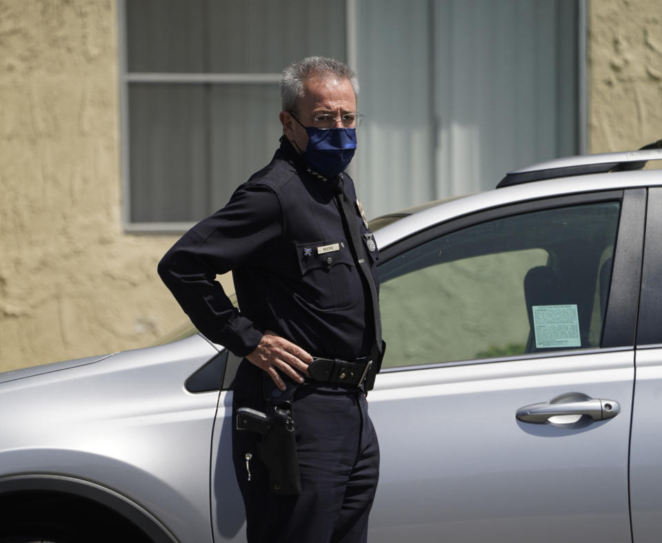 Los Angeles police Lt. Raul Jovel talks to the media gathered as Los Angeles police investigate the scene of a crime at an apartment complex in Reseda, Calif., Saturday, April 10, 2021. A woman discovered her three grandchildren — all under the age of 5 — slain inside a Los Angeles apartment Saturday morning and their mother gone, police said. The mother of three children — all under the age of 5 — found slain inside a Los Angeles apartment Saturday morning has been arrested, police said. (AP Photo/Damian Dovarganes)