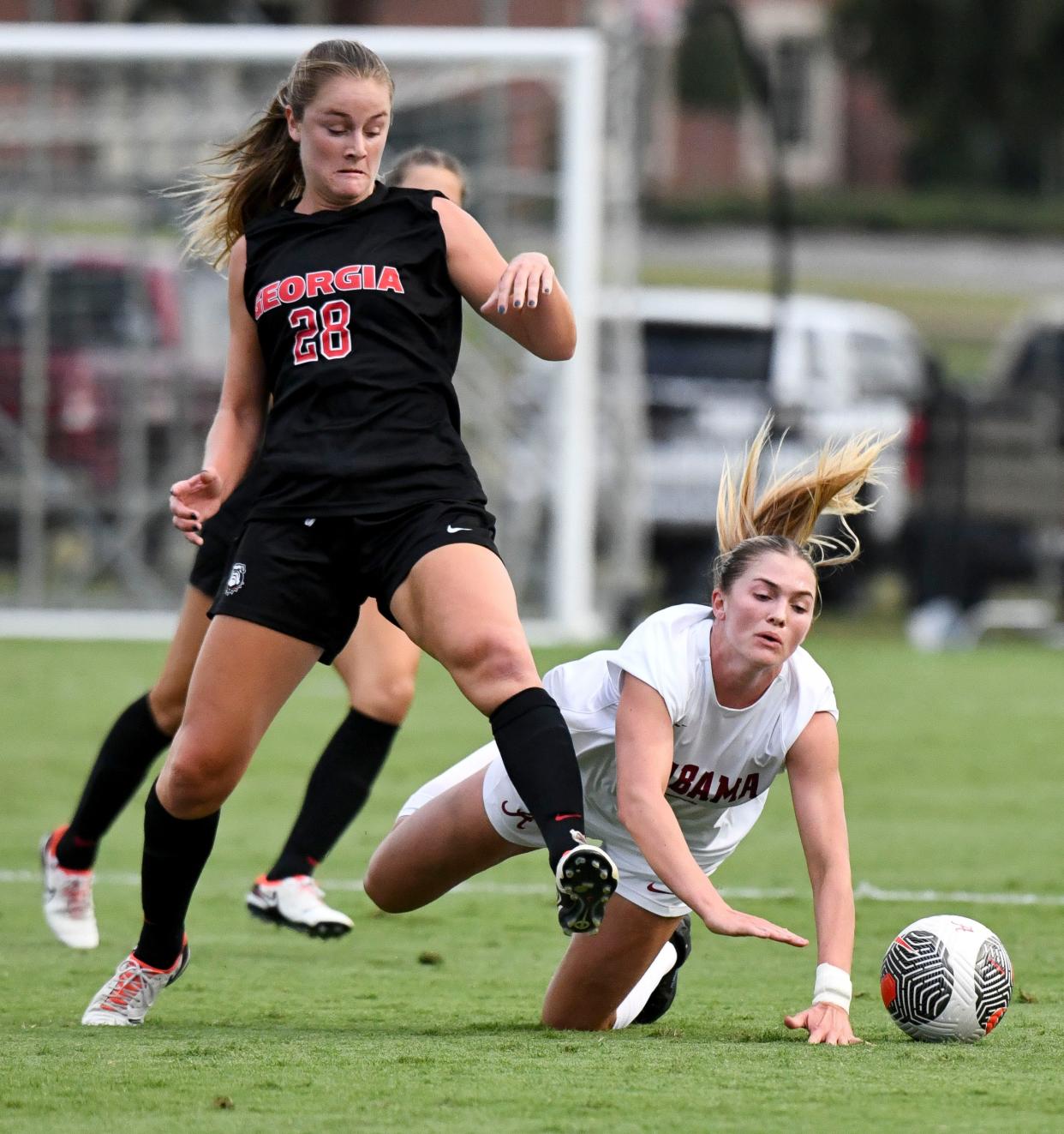 Georgia midfielder Mallie McKenzie knocks down Alabama defender Marianna Annest (13) as they vie for the ball. Alabama and Georgia played to a 1-1 tie at the Alabama Soccer Stadium Thursday, Sept. 14, 2023.