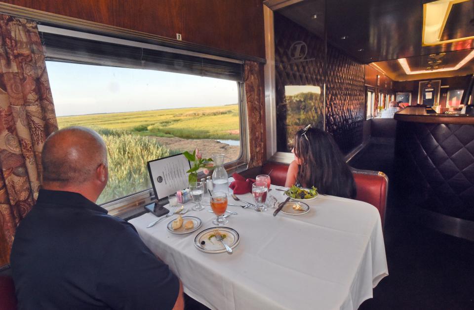 In the 1917 car Brian and Linda Millett, of Bridgewater, look out on the Great Salt Marsh on the Cape Cod Central Railroad Dinner train.