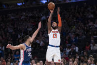 New York Knicks forward Marcus Morris Sr. (13) shoots a three-point basket past Philadelphia 76ers guard Ben Simmons (25) in the second half of an NBA basketball game, Saturday, Jan. 18, 2020, at Madison Square Garden in New York. (AP Photo/Mary Altaffer)