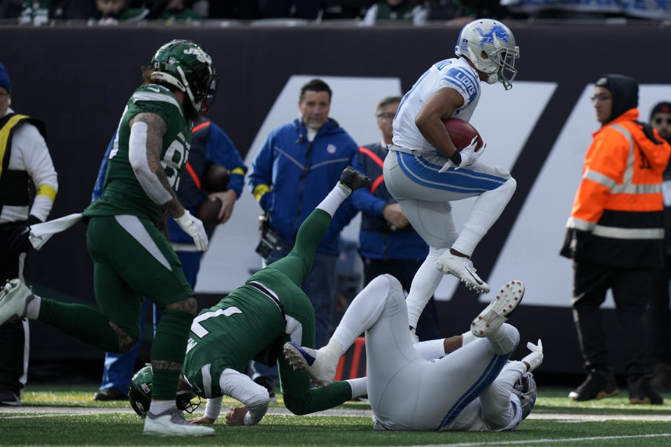 Detroit Lions wide receiver Kalif Raymond (11) returns a punt for a touchdown against the New York Jets during the first quarter of an NFL football game, Sunday, Dec. 18, 2022, in East Rutherford, N.J. (AP Photo/Bryan Woolston)