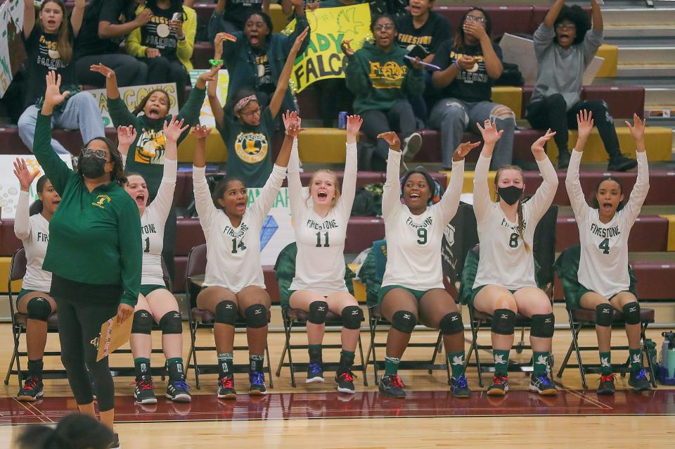 The Firestone bench celebrates an ace serve by Tiara Williams against Ellet in the City Series volleyball championship on Thursday, Oct. 13, 2022 in Akron, Ohio, at Garfield High School.