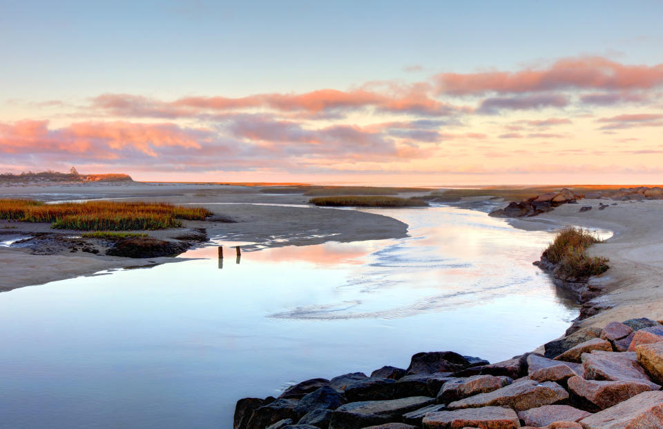 Water and rocky beach at sunset