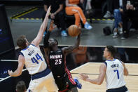 Miami Heat guard Kendrick Nunn (25) goes up for a shot against Dallas Mavericks forward Nicolo Melli (44) and center Dwight Powell (7) during the first half of an NBA basketball game, Tuesday, May 4, 2021, in Miami. (AP Photo/Wilfredo Lee)