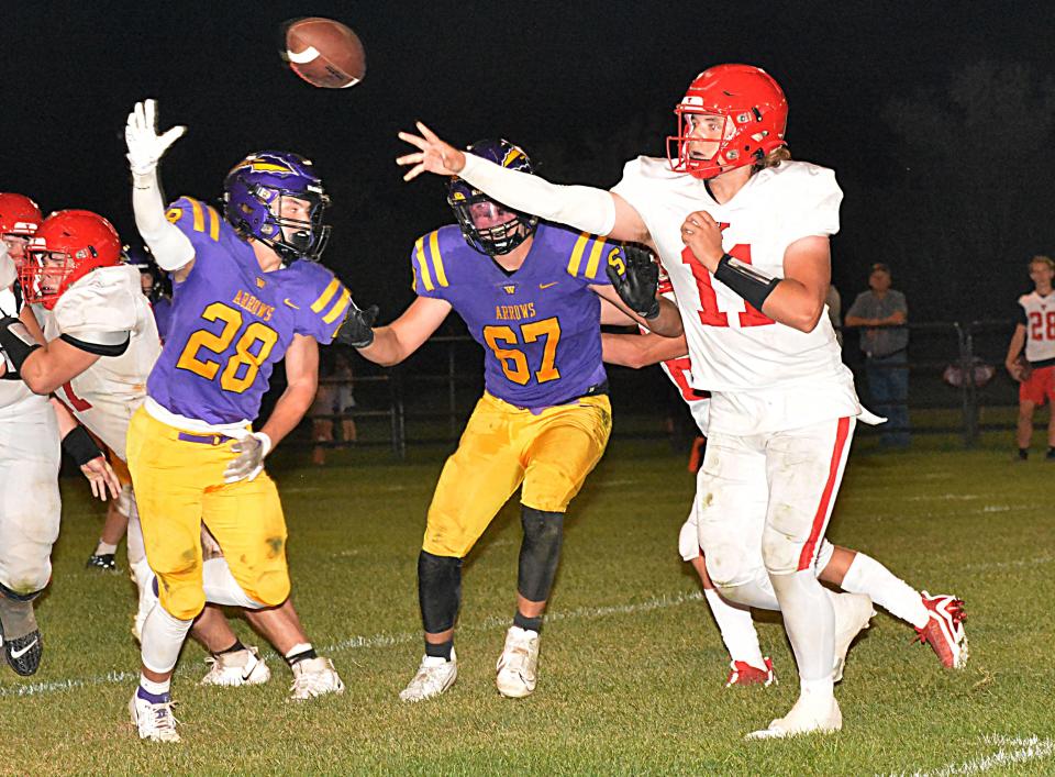 Yankton quarterback Lucas Kampshoff throws a pass while being pressured by Watertown's Kaden Decker (28) and Caden Beauchamp (68) during their Eastern South Dakota Conference football game on Friday, Sept. 8, 2023 at Watertown Stadium.