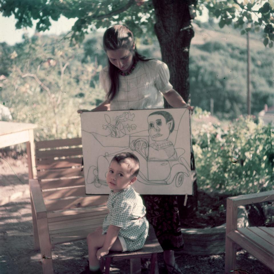 Gilot with her son Claude, holding drawings of him by Picasso, in Vallauris, France, 1949 - Getty Images