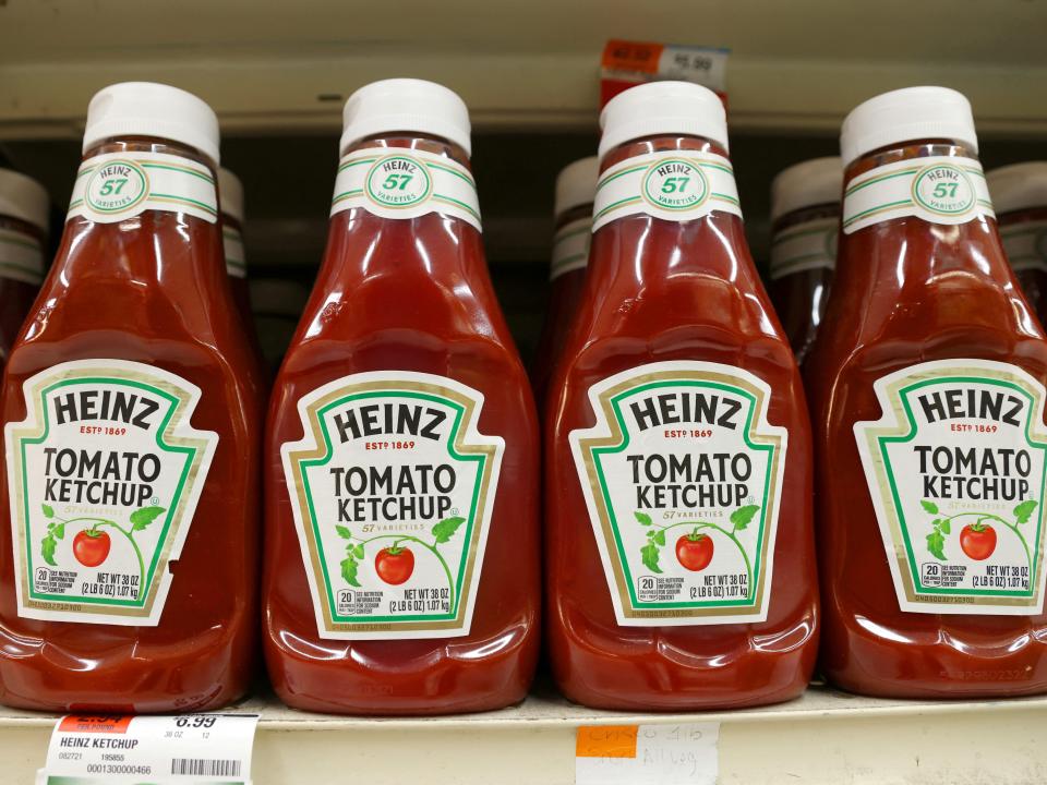 Bottles of Heinz ketchup, each bearing the number 57 on its label, sit on a grocery shelf.