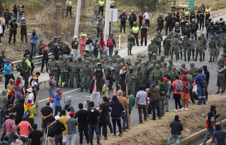 Soldiers prepare to remove a road block during protests after Ecuador's President Lenin Moreno's government ended four-decade-old fuel subsidies, in Calderon near Quito