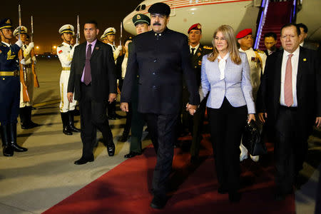 Venezuela's President Nicolas Maduro walks with his wife Cilia Flores upon their arrival at the airport in Beijing, China September 13, 2018. Miraflores Palace/Handout via REUTERS