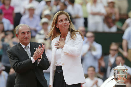 FILE PHOTO: French Tennis Federation (FFT) President Jean Gachassin (L) and former Spanish tennis player Arantxa Sanchez-Vicario applaud after presenting trophies to Serena Williams of the U.S. and runner-up Maria Sharapova of Russia following the women's singles final match at the French Open tennis tournament at the Roland Garros stadium in Paris June 8, 2013. REUTERS/Vincent Kessler/File Photo