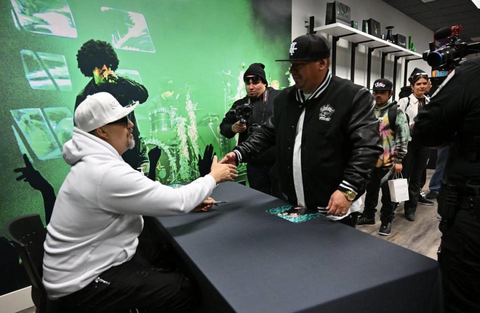 B-Real, of hip hop group Cypress Hill, left, greets customers at Dr. Greenthumbs, Fresno newest cannabis dispensary, which opened in a former bank in the Tower District Saturday morning, April 6, 2024 in Fresno.