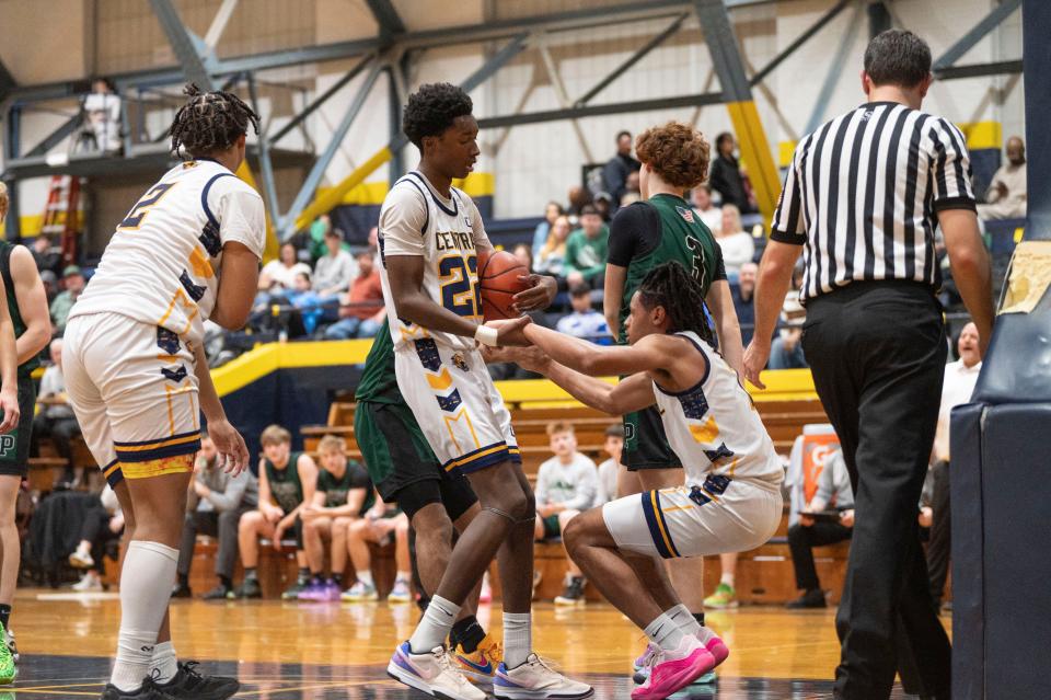 Battle Creek Central junior Jeremiah Warren helps up senior Josh Harris during the Chuck Turner Holiday Classic at Battle Creek Central High School on Thursday, Dec. 28, 2023.