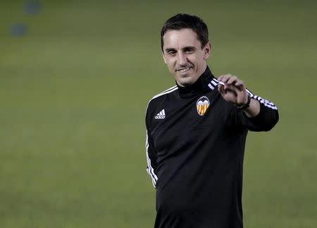Valencia's new coach Gary Neville greets the public during his first training session in Valencia, Spain, December 7, 2015. REUTERS/Heino Kalis