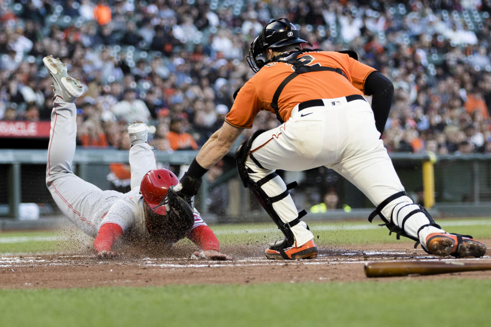 San Francisco Giants catcher Curt Casali, right, tags out Cincinnati Reds' Nick Senzel during the second inning of a baseball game in San Francisco, Friday, June 24, 2022. (AP Photo/John Hefti)