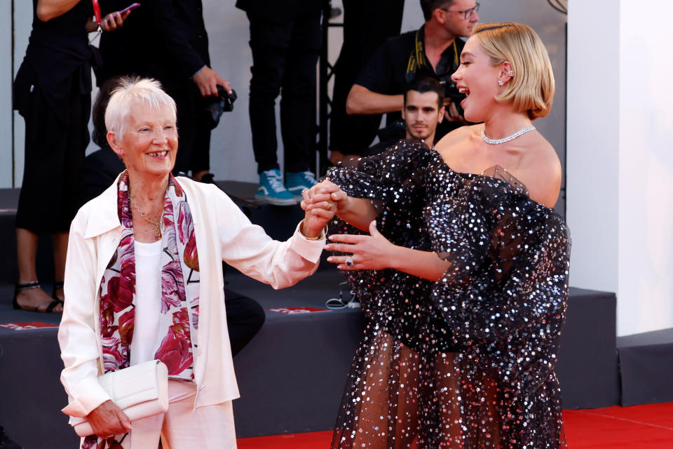 Florence smiles and holds her grandma's hand up