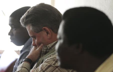 Zimbabwean hunter Theo Bronkhorst (C) waits to appear in Hwange magistrates court, July 29, 2015. REUTERS/Philimon Bulawayo