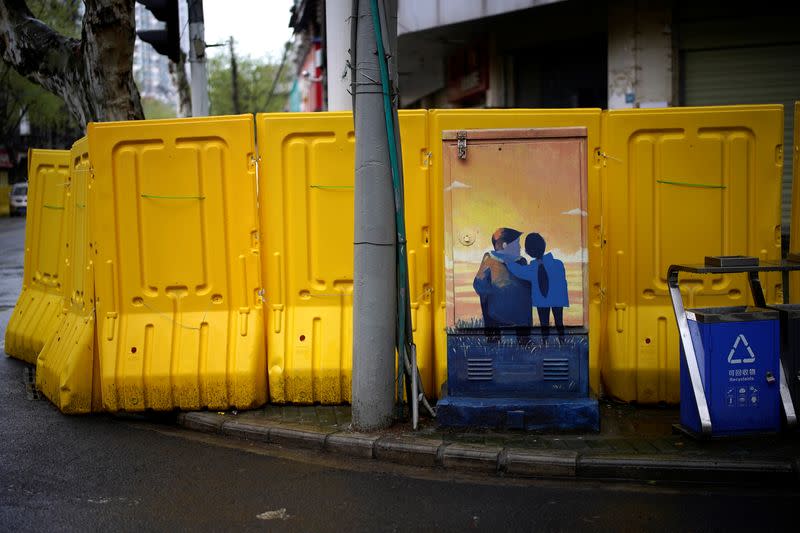 Painted power box is seen near barricades built up to block residential buildings from streets in Wuhan