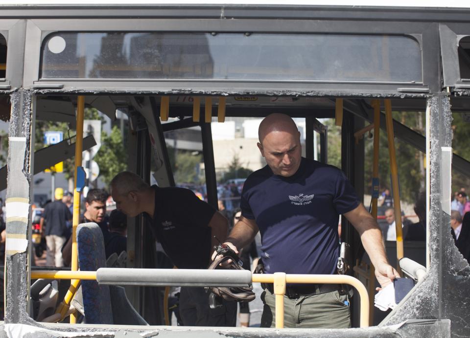 TEL AVIV, ISRAEL- NOVEMBER 21: Emergency services at the scene of an explosion on a bus with passengers onboard on November 21, 2012 in central Tel Aviv, Israel. At least ten people have been injured in a blast on a bus near military headquarters in what is being described as terrorist attack which threatens to derail ongoing cease-fire negotiations between Israeli and Palestinian authorities. (Photo by Ziv Oren/Getty Images)