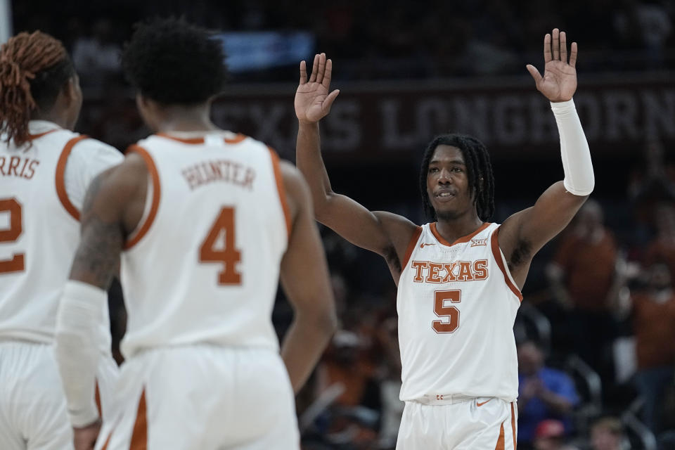 Texas guard Marcus Carr (5) celebrates a score with teammates during the second half of an NCAA college basketball game against Texas A&M-Commerce in Austin, Texas, Tuesday, Dec. 27, 2022. (AP Photo/Eric Gay)