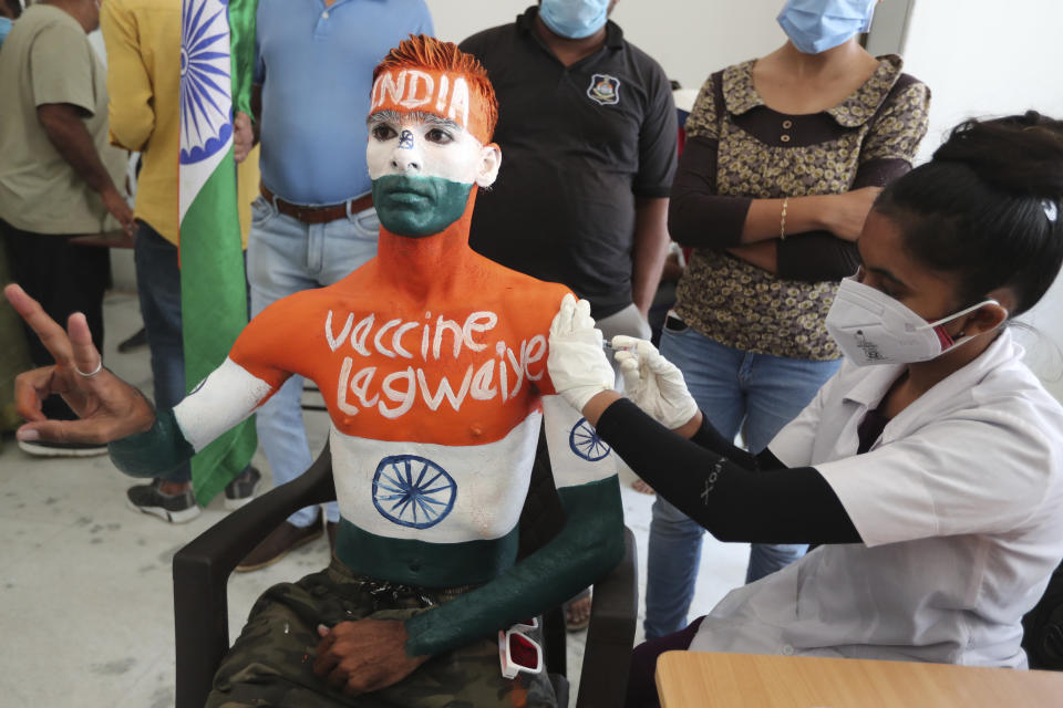 Rajkumar Haryani, 38, receives a dose of Covishield, Serum Institute of India's version of the AstraZeneca COVID-19 vaccine, in Ahmedabad, India, Saturday, June 12, 2021. Rajkumar painted his body to create awareness about vaccination. (AP Photo/Ajit Solanki)