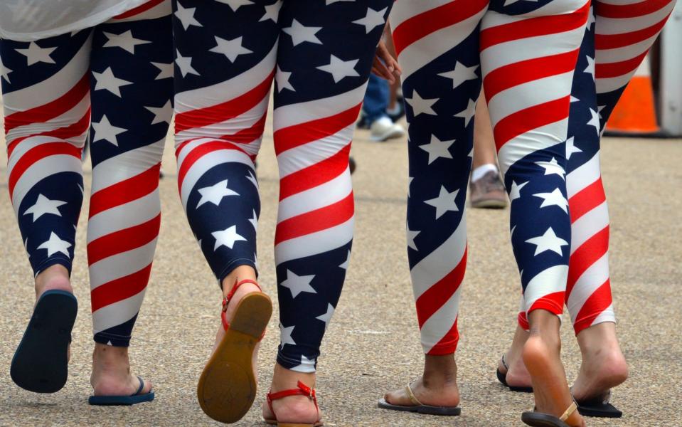 Four young women wear US flag leggings - AFP