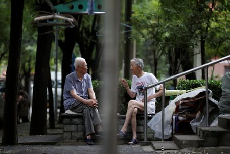 Elderly men chat at a residential community in downtown Beijing