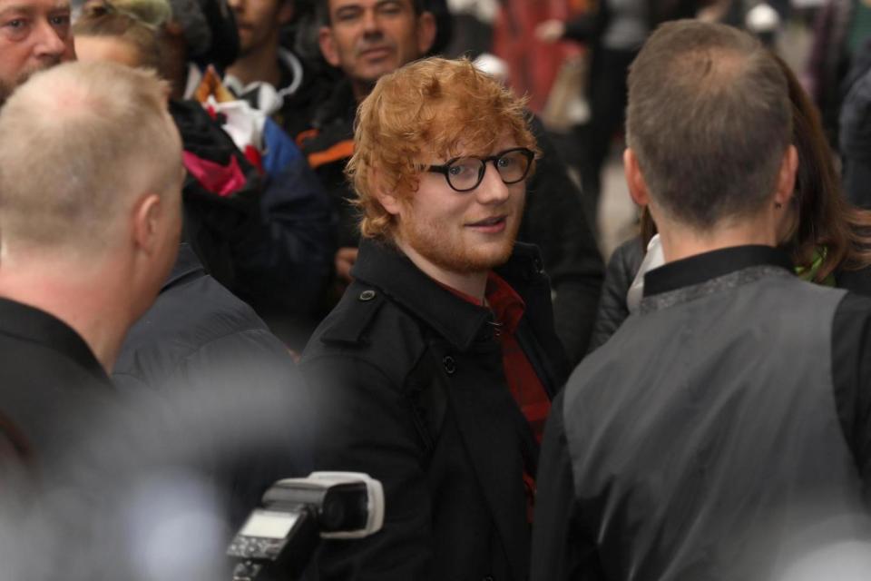 Ed Sheeran arrived with his wrist in a sling. (Tim P. Whitby/Getty Images)