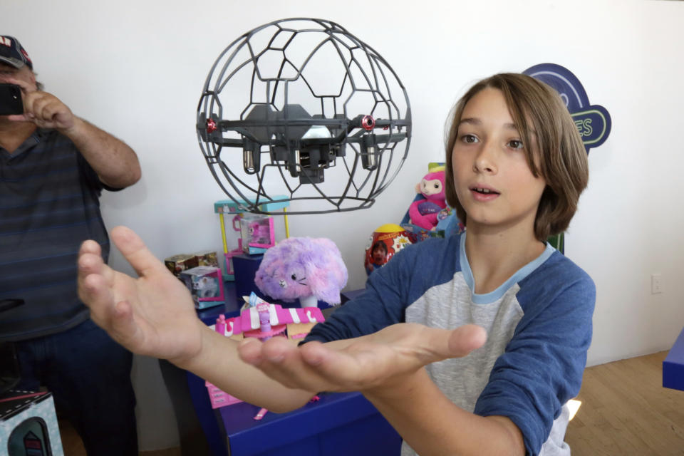 In this Aug. 30, 2018, photo Gabriel, 12, plays with an Air Hogs Supernova quadcopter at the Walmart Toy Shop event in New York. Walmart says 30 percent of its holiday toy assortment will be new. It will also offer 40 percent more toys on Walmart.com from a year ago. In November and December, the company’s toy area will be rebranded as “America’s Best Toy Shop.” (AP Photo/Richard Drew)