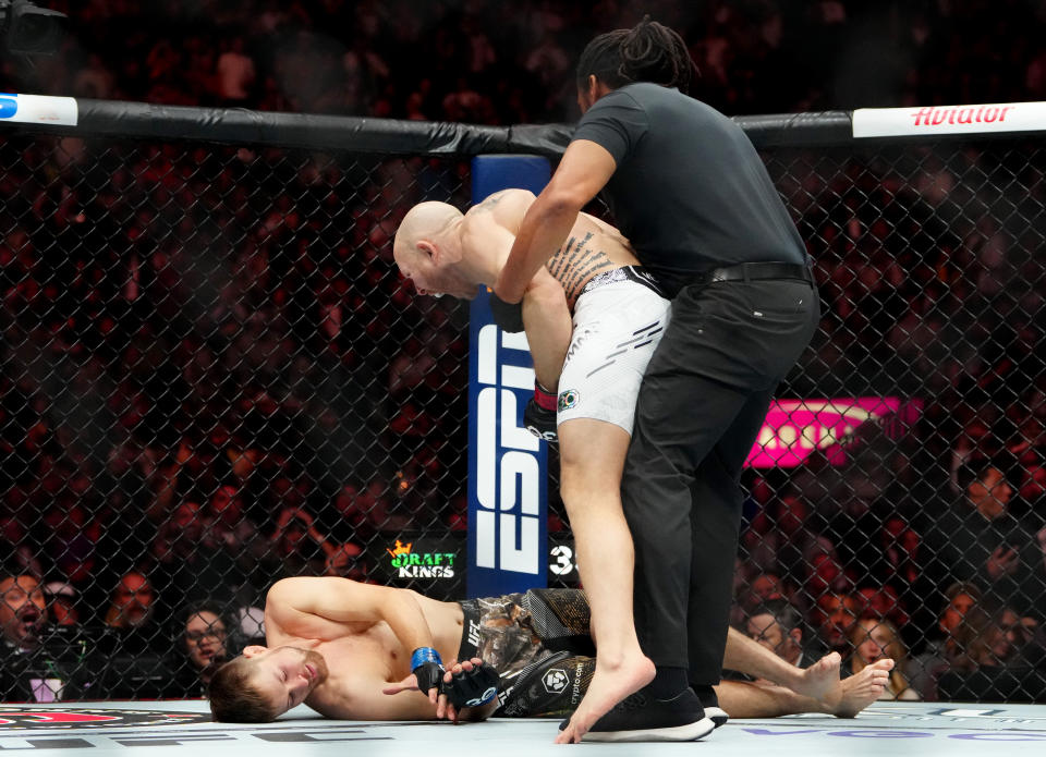 Dec 16, 2023; Las Vegas, Nevada, USA; Josh Emmett (red gloves) reacts after knocking out Bryce Mitchell (blue gloves) during UFC 296 at T-Mobile Arena. Mandatory Credit: Stephen R. Sylvanie-USA TODAY Sports