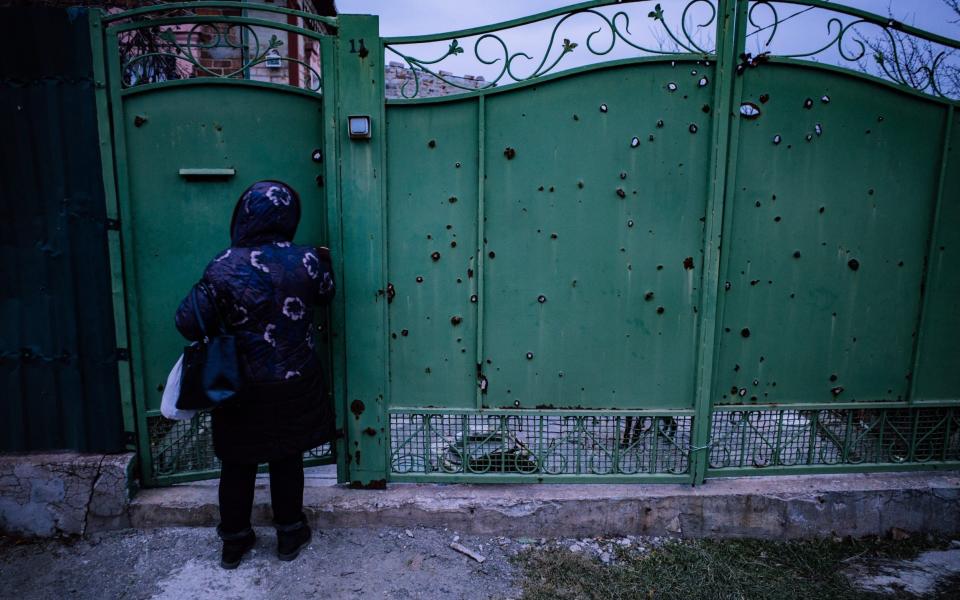 Olga lives behind this battered green gate - Jan-Vidar Bakke