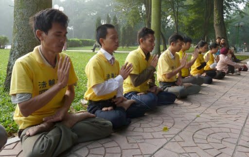 Vietnamese Falungong followers sit in meditation in front of Chinese embassy in Hanoi. Falungong practitioners say communist authorities in Vietnam have bowed to pressure from China, using police and hired thugs to harass, assault and detain members of the movement