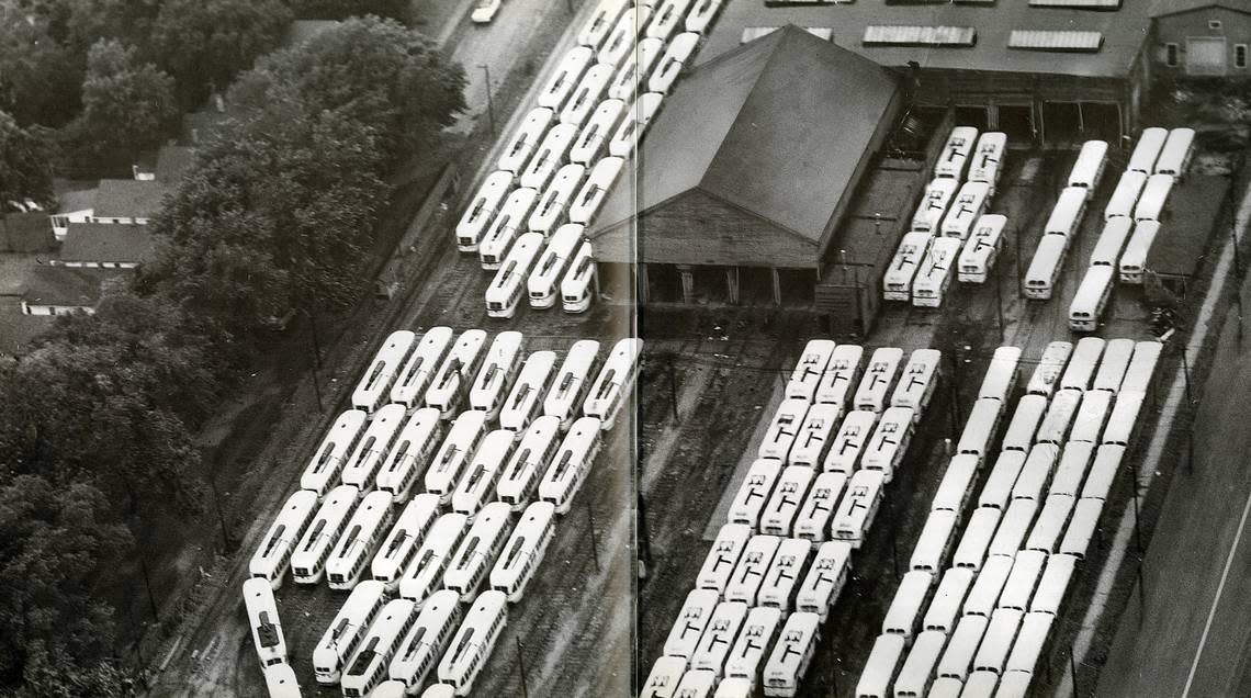 Decommissioned street cars and new city buses housed at 48th and Troost, 1957.