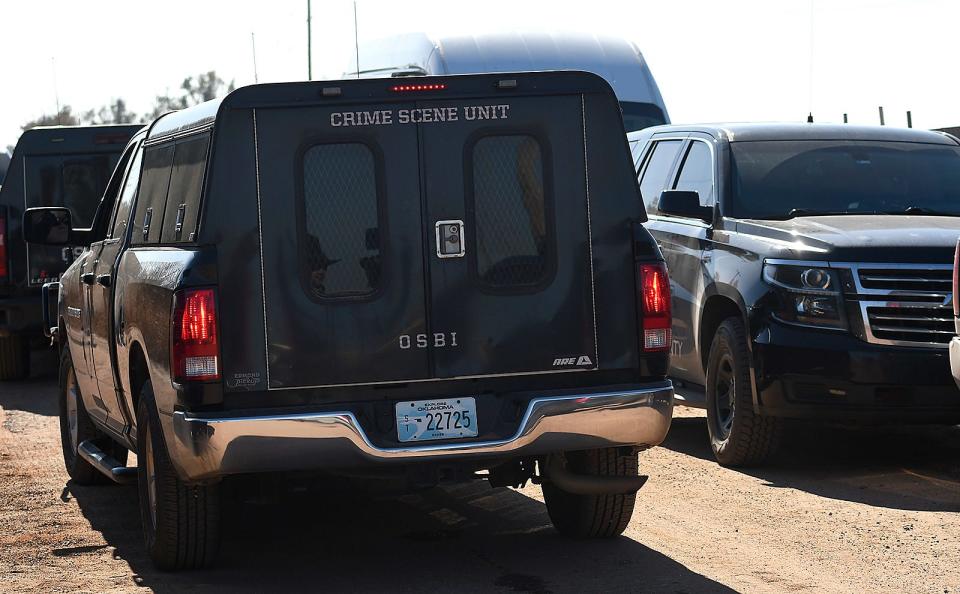 Oklahoma Bureau of Investigation crime scene unit vehicle sits Monday, Nov. 21, 2022, at the scene near Lacey, Oklahoma, where four people were killed. State police in Oklahoma say that four people killed at a marijuana farm were "executed," and that they were Chinese citizens.