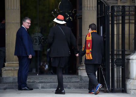 A mourner wearing a Harry Potter themed scarf arrives to attend the funeral of journalist Lyra McKee at St. Anne's Cathedral in Belfast, Northern Ireland April 24, 2019. REUTERS/Clodagh Kilcoyne